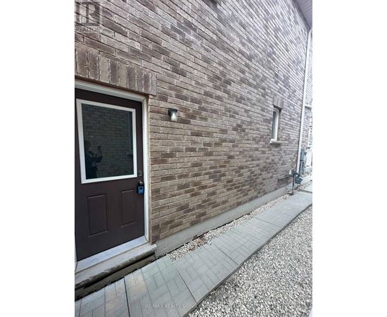 A brown door is on a brick wall.