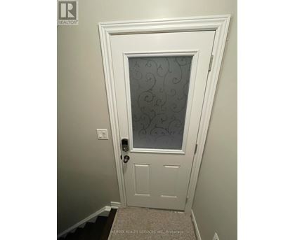 A white door with a glass window and a handle.