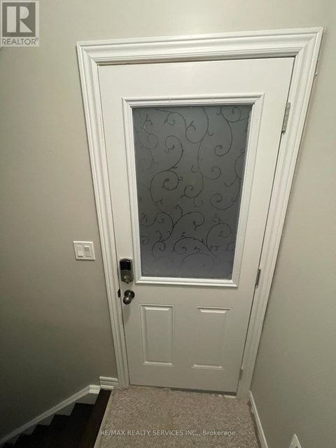 A white door with a glass window and a handle.