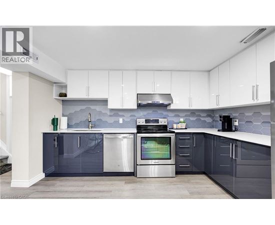 A modern kitchen with a stainless steel dishwasher and oven.