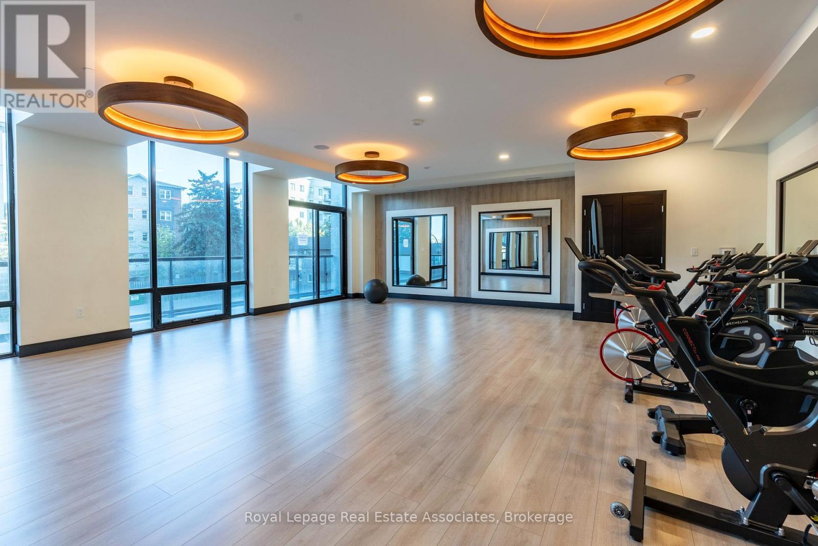 A gym with treadmills and elliptical machines.