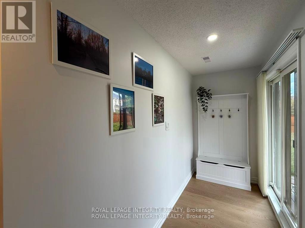 A white room with a large window and a white cabinet.