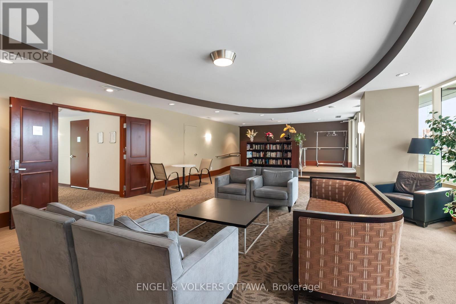 A living room with a grey couch and a brown chair.