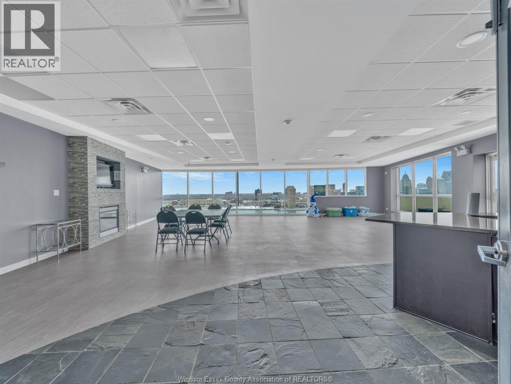 A spacious office room with a view of the cityscape outside the windows.