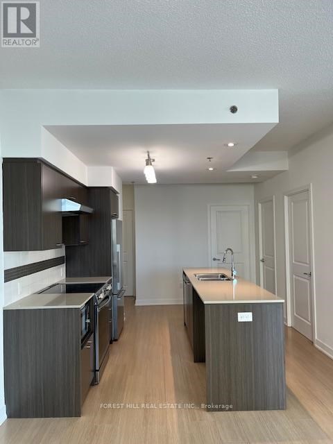 A modern kitchen with dark wood cabinets and a white island.