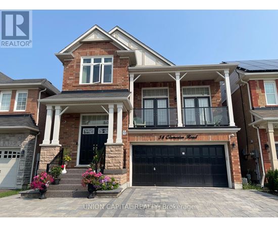 A large brick house with a black garage door and a sign that says "St. Clements Road.".