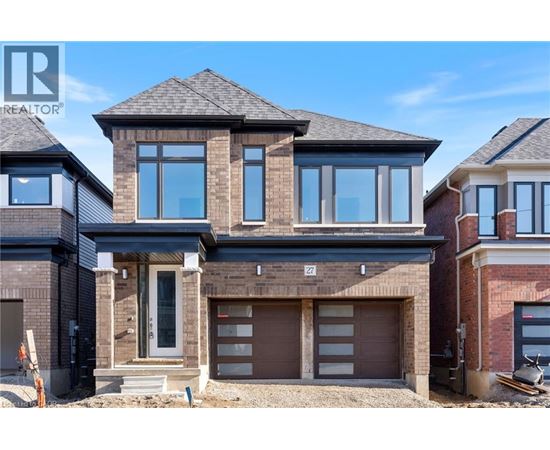 A modern house with a large front yard is for sale.
