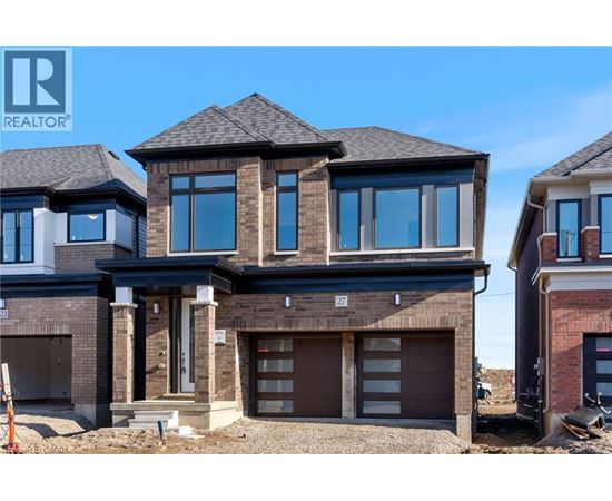 A modern house with a large garage is for sale.