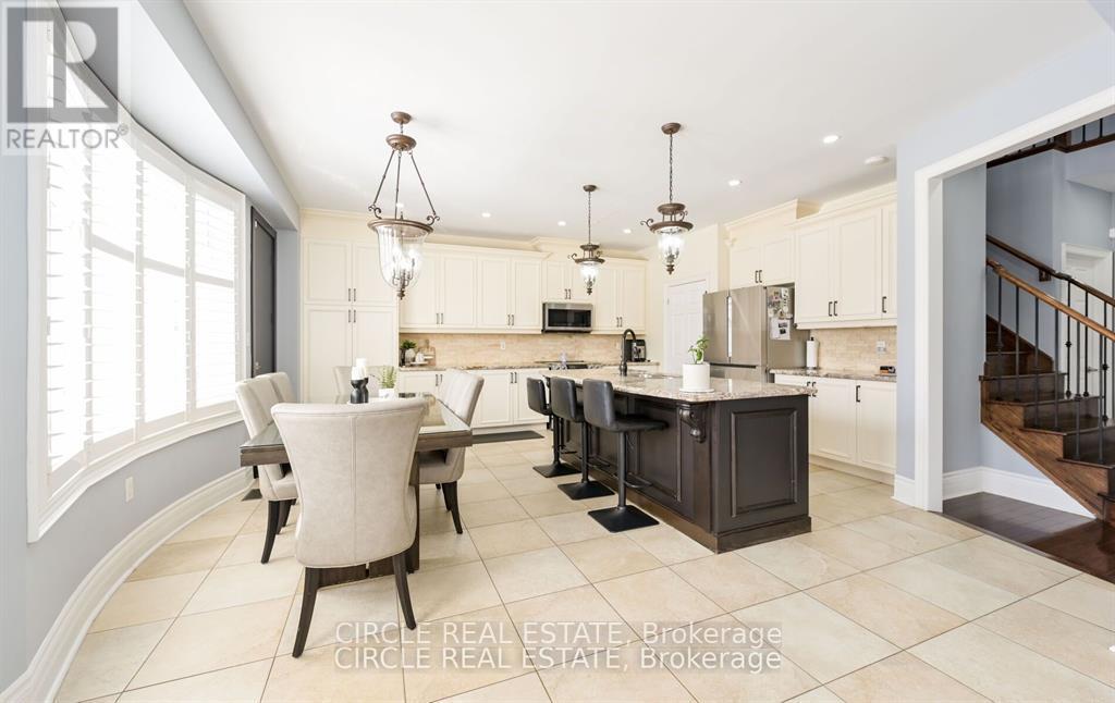 A well-lit kitchen with a dining table and chairs.