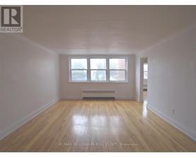 A room with wooden floors and a window.