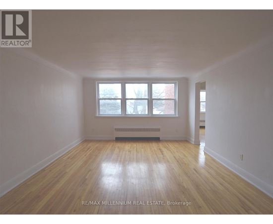 A room with wooden floors and a window.