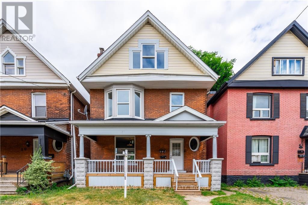 A house with a red brick exterior and a white porch.