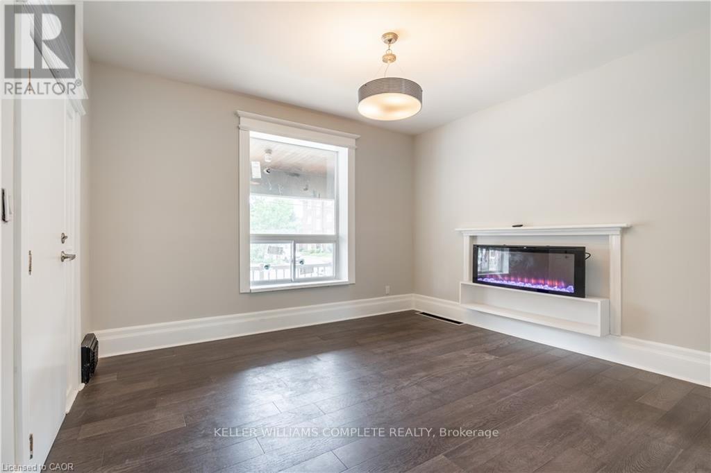 A living room with a flat screen TV mounted on the wall.