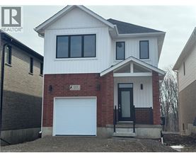 A two-story house with a garage is for sale.