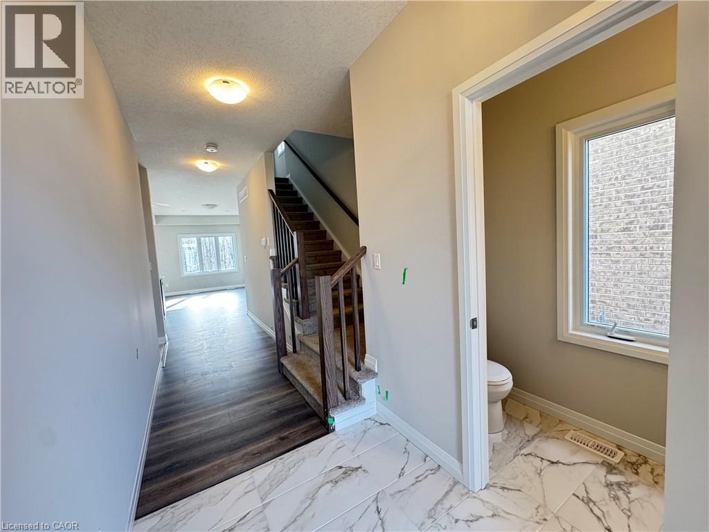 A room with a staircase and a toilet.
