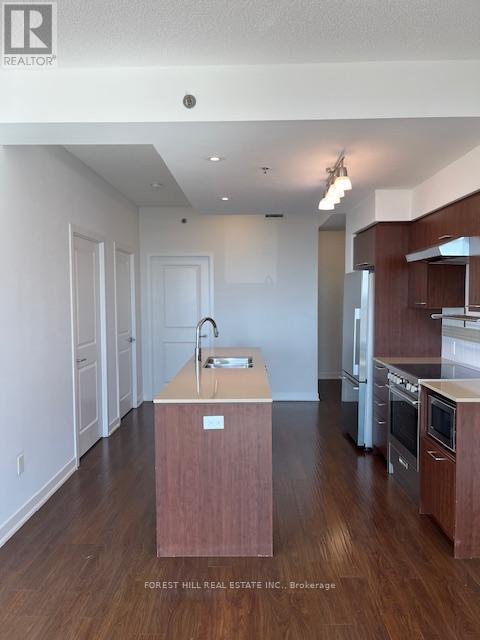 A kitchen with a sink and a wooden island.