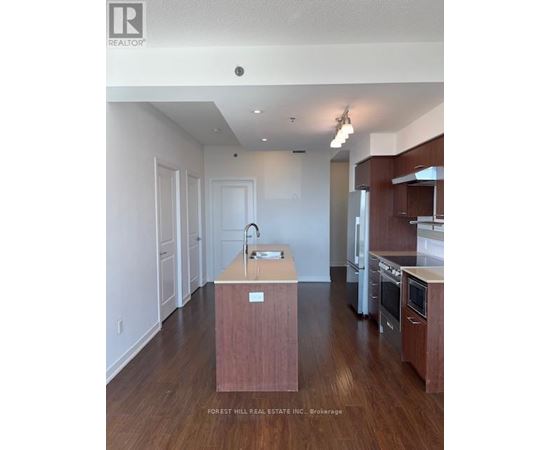 A kitchen with a sink and a wooden island.