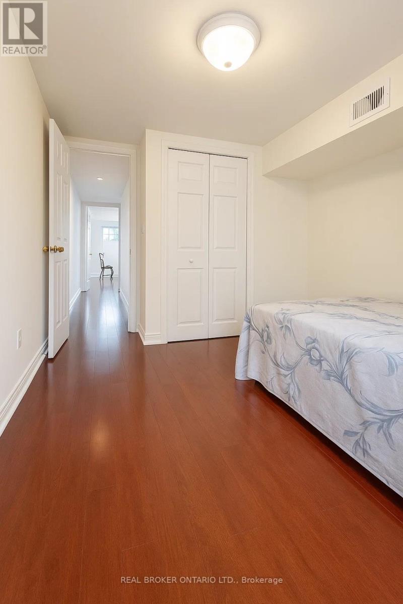 A bedroom with a bed and a doorway leading to another room.