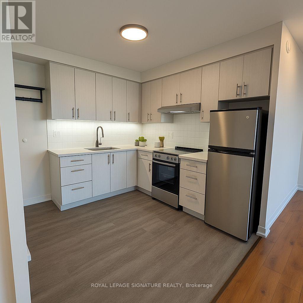 A kitchen with white cabinets and stainless steel appliances.