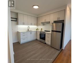 A kitchen with white cabinets and stainless steel appliances.