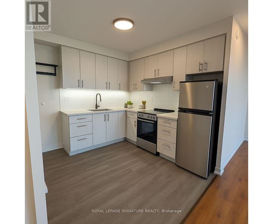 A kitchen with white cabinets and stainless steel appliances.