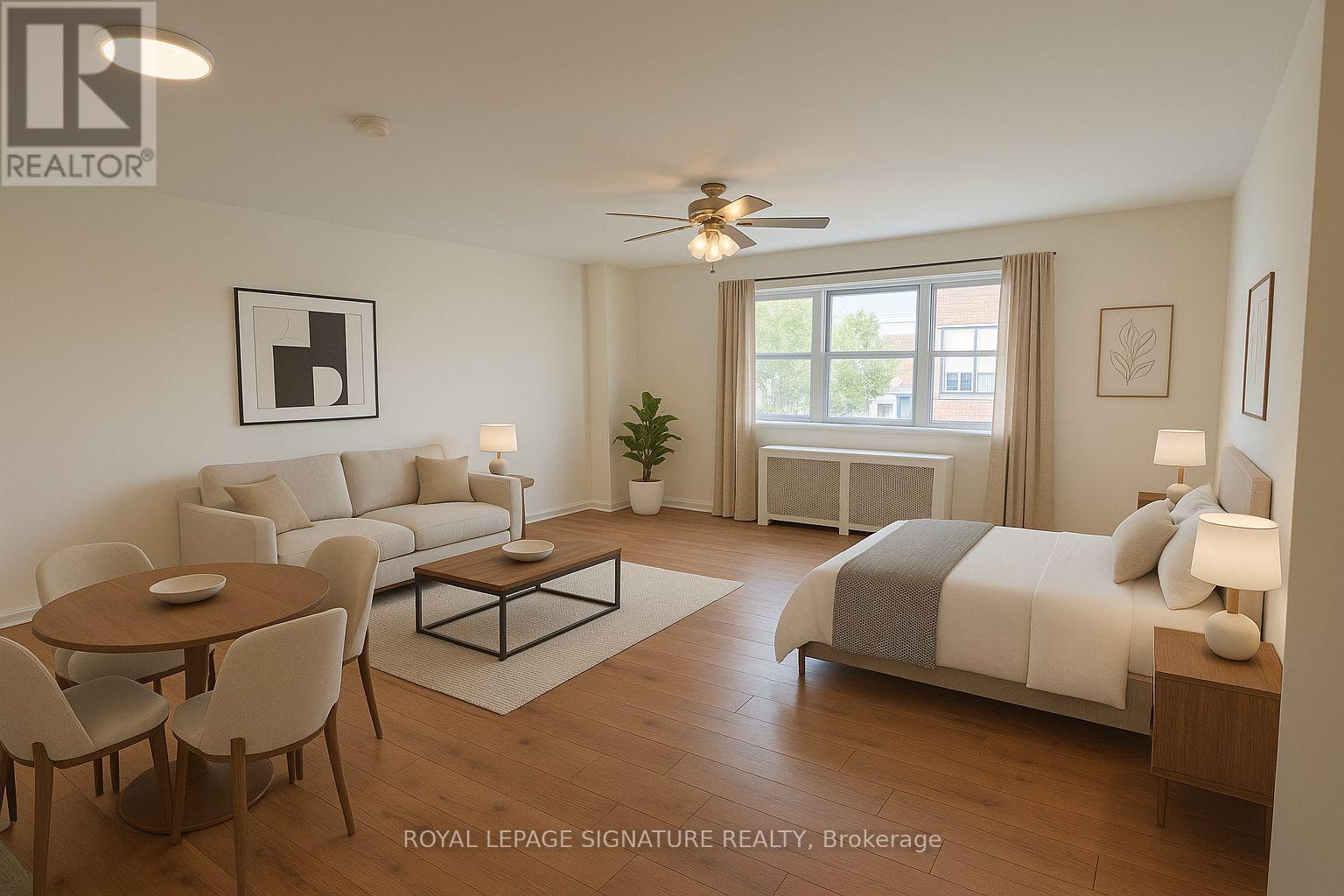 A well-lit, spacious bedroom and living room with a dining table and chairs.