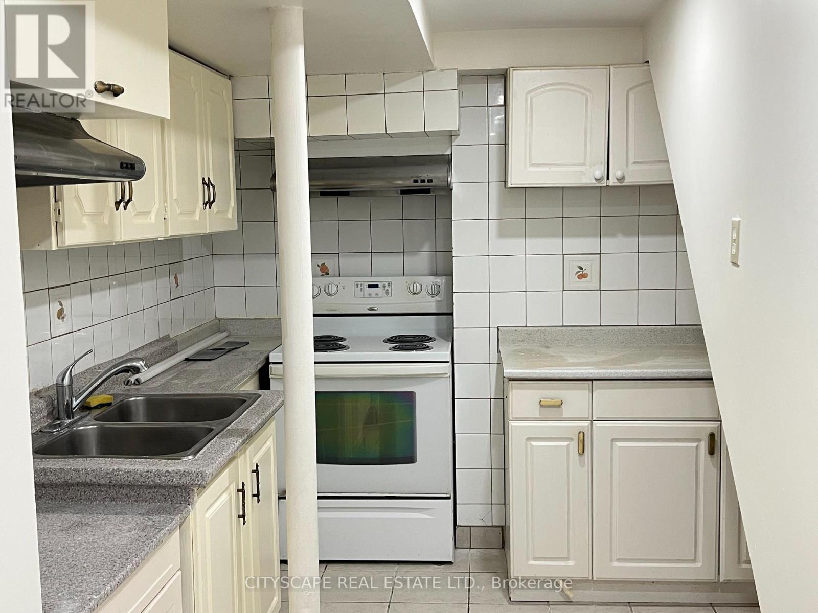 A kitchen with white appliances and cabinets.