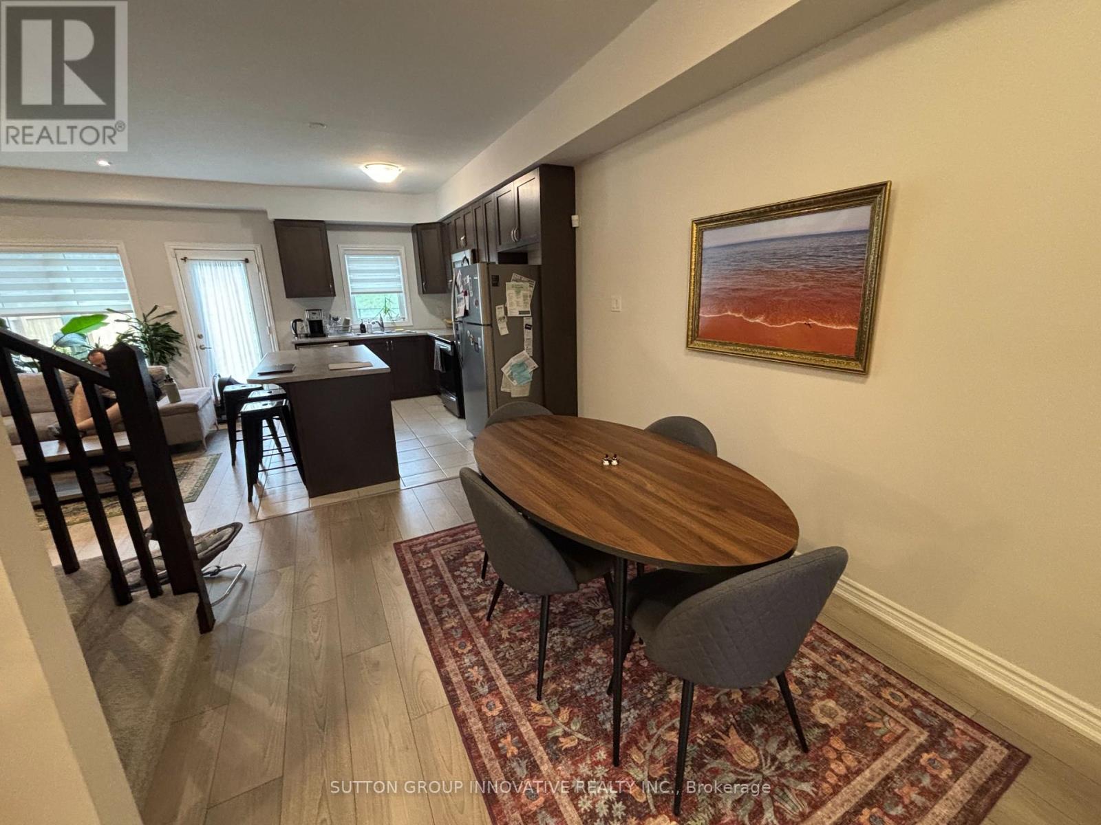 A dining room with a wooden table and chairs.