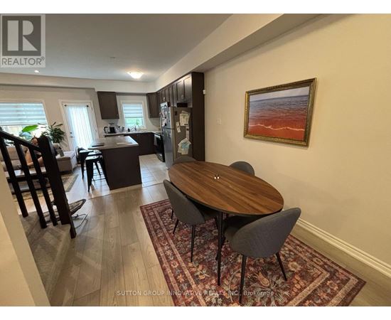 A dining room with a wooden table and chairs.