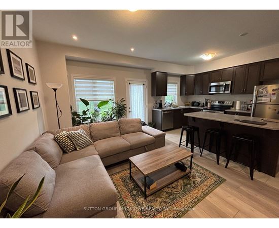 A living room with a brown couch and a coffee table.