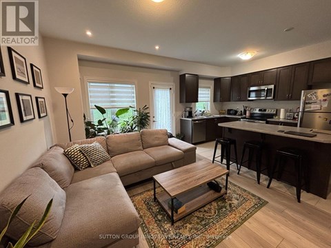 A living room with a brown couch and a coffee table.