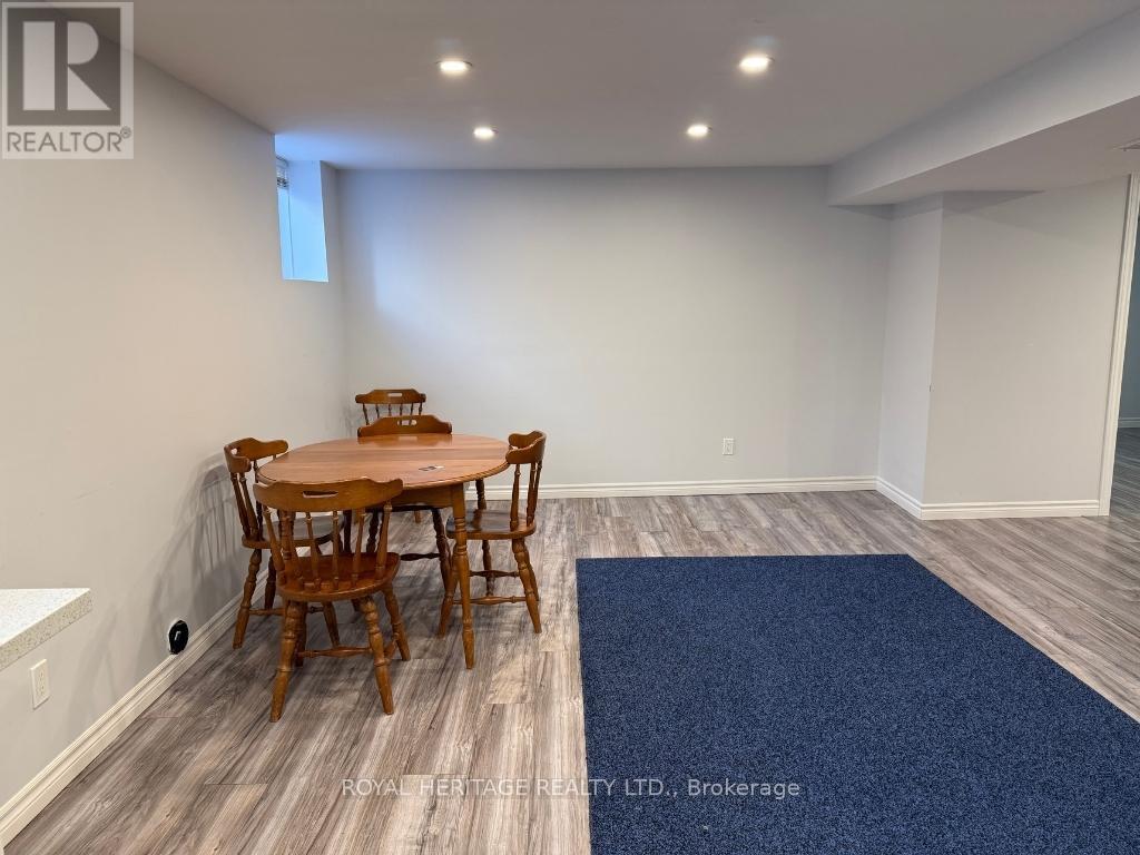 A dining room with a wooden table and chairs.