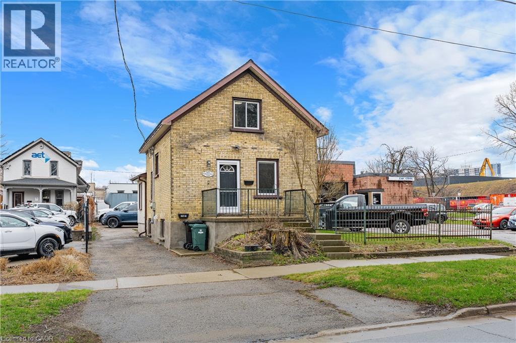 A house with a REALTOR® sign in front of it.