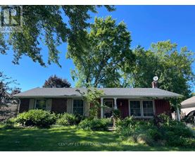 A house with a sign that says "Century 21 First Canadian Corp Brokers".
