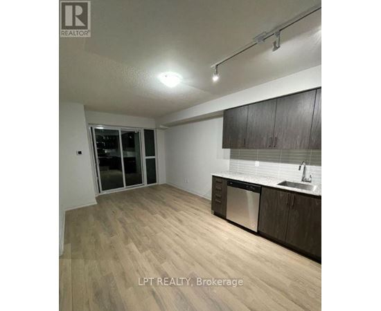 A kitchen with wooden floors and a sink.