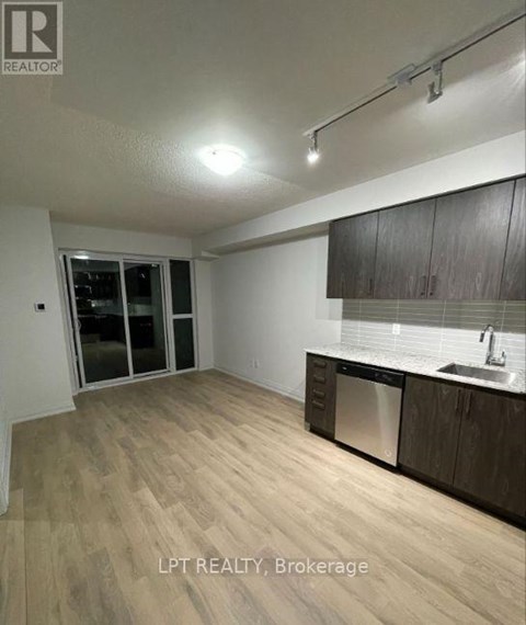 A kitchen with wooden floors and a sink.