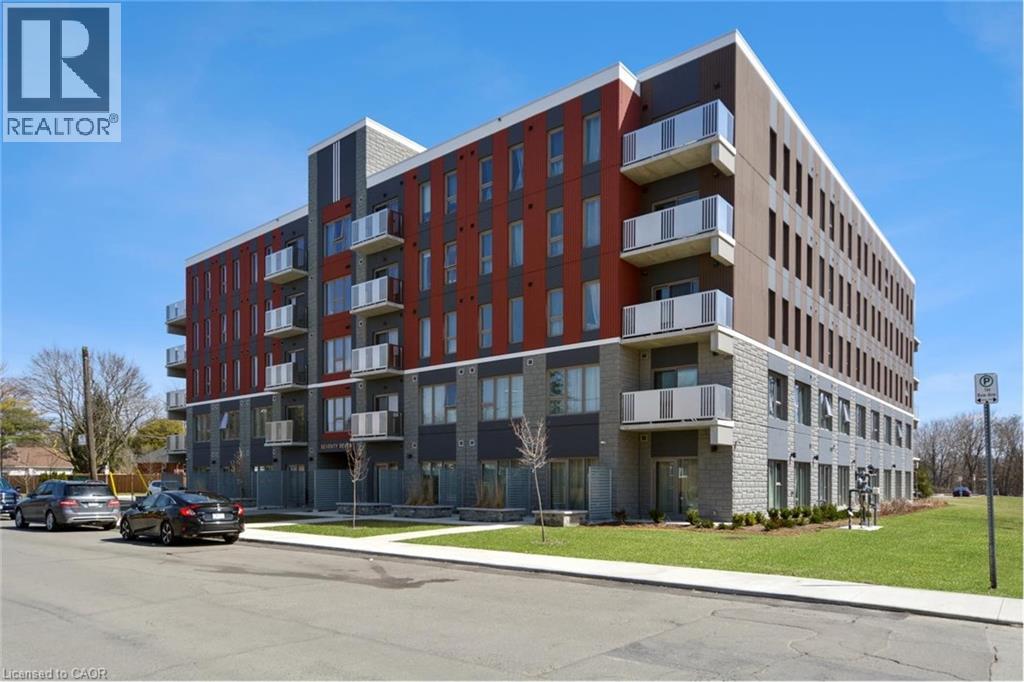 A modern apartment building with a clear blue sky in the background.