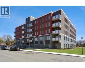 A modern apartment building with a clear blue sky in the background.