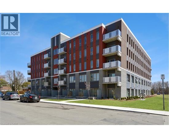 A modern apartment building with a clear blue sky in the background.
