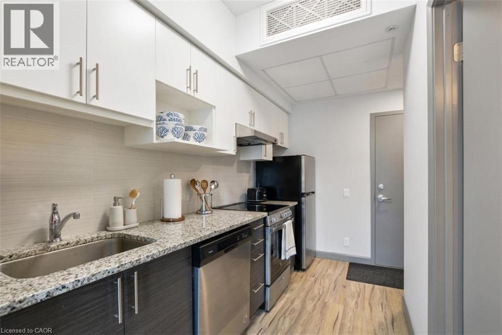 A kitchen with a sink, stove, and refrigerator.