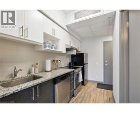 A kitchen with a sink, stove, and refrigerator.