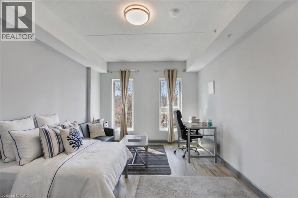 A bedroom with a large bed and a desk with a chair.
