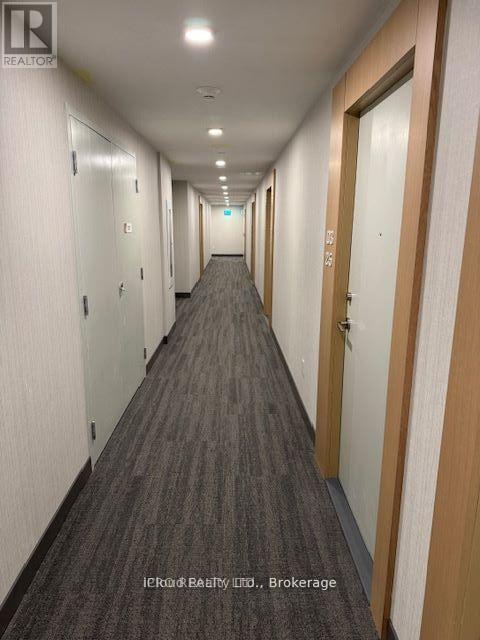 A long hallway with doors on both sides.