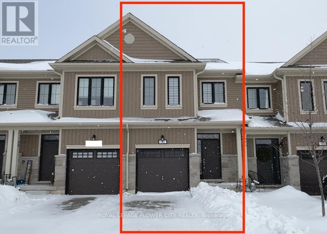 A large house with a brown and beige exterior is surrounded by snow.