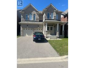 A house with a car parked in front of it.