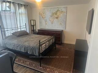 A bedroom with a large bed and a world map on the wall.