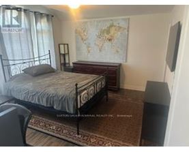 A bedroom with a large bed and a world map on the wall.