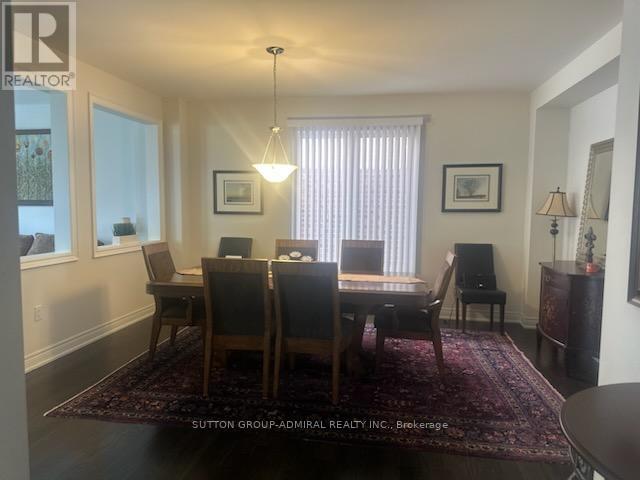 A dining room with a table and chairs.