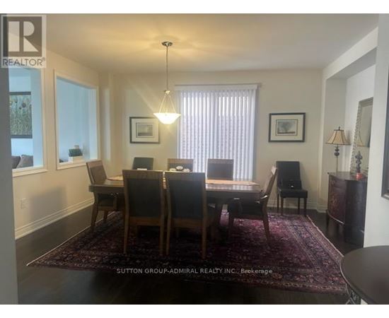 A dining room with a table and chairs.