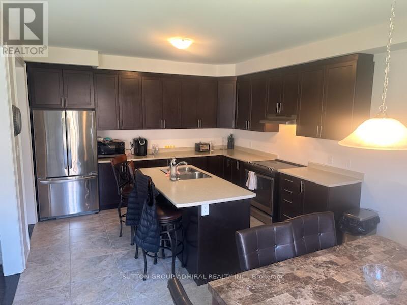 A kitchen with a table and chairs.